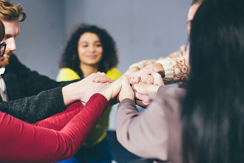 lgbt friendly rehab centers a group of people hold hands at one of the few LGBT friendly rehab centers